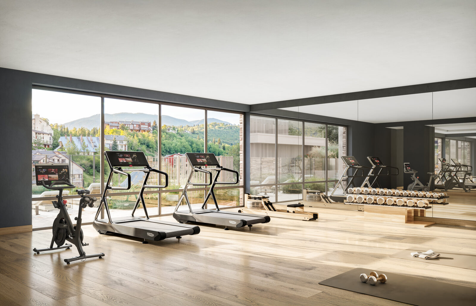Wildair fitness center with treadmills, stationary bike, free weights and floor-to-ceiling Steamboat views