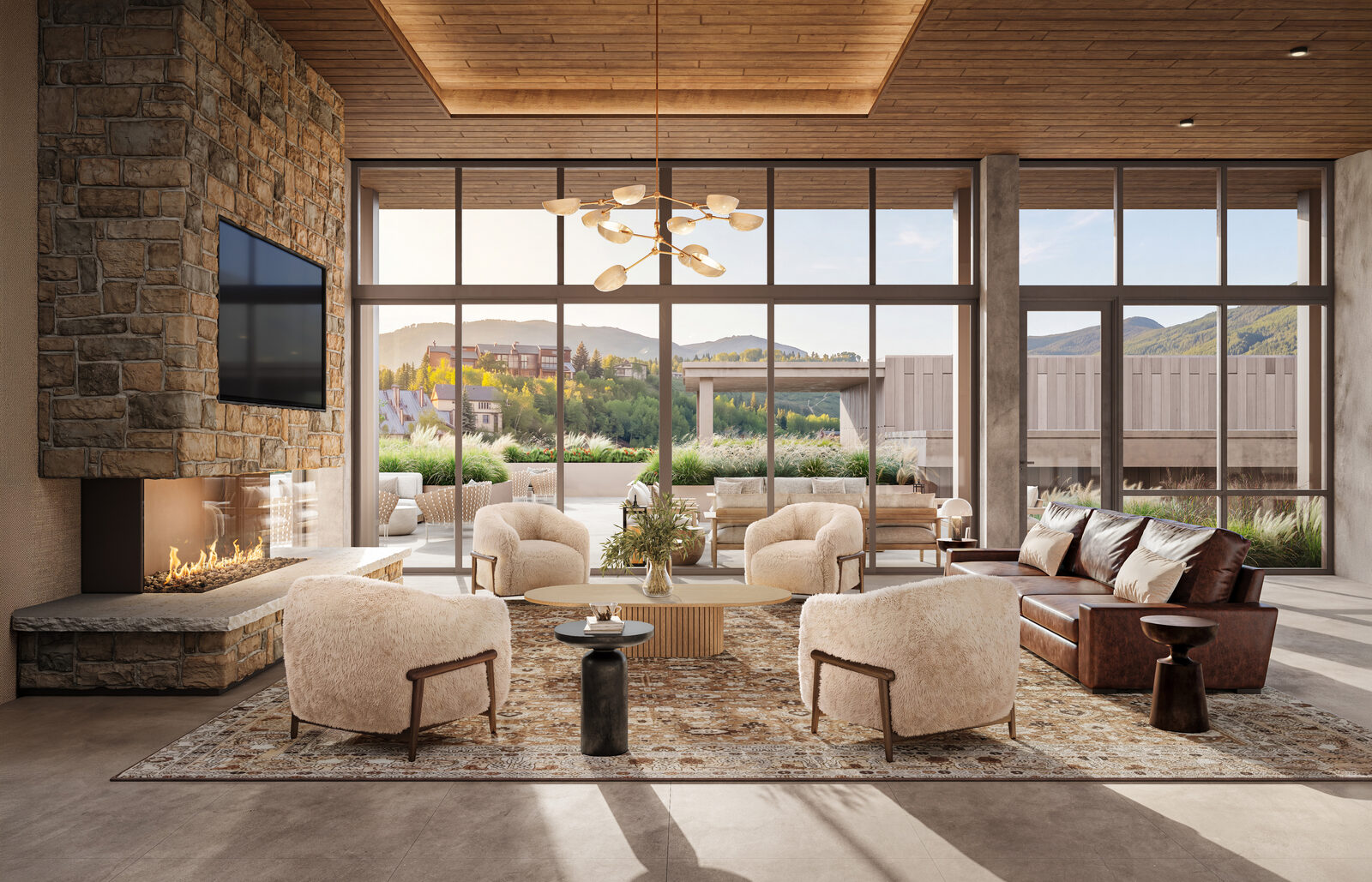Wildair Owners Club lounge with stone fireplace, plush seating and floor-to-ceiling views of the Steamboat mountains