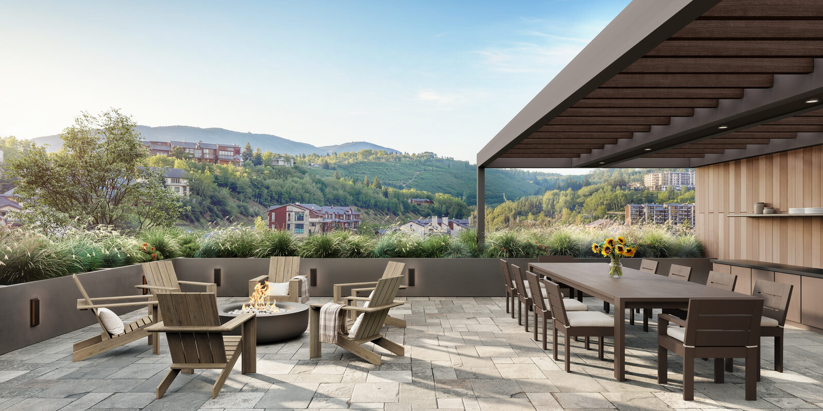 Wildair Owners Club terrace with fire pit, outdoor dining table and panoramic summer views across Steamboat