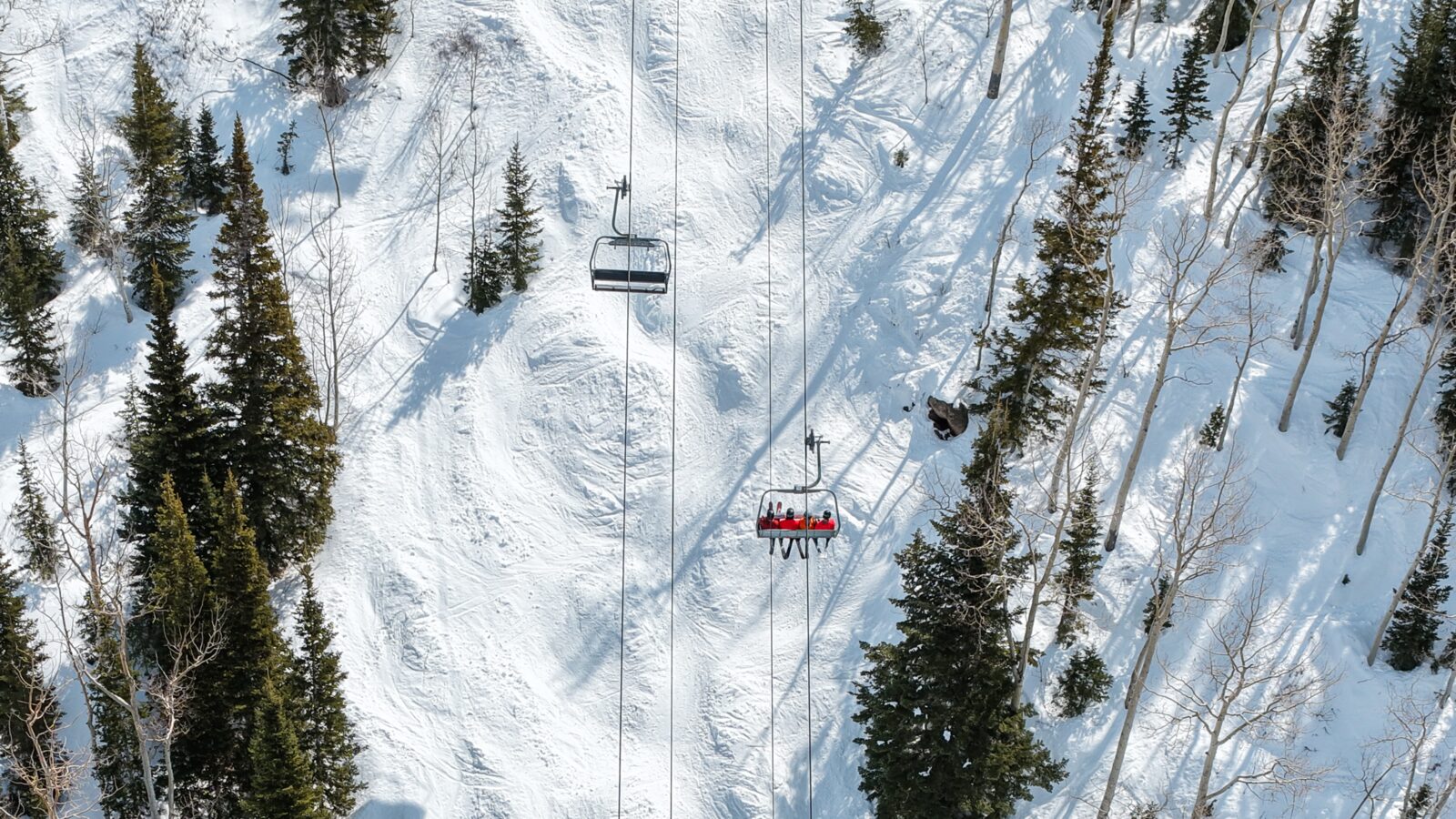 Chair lift crossing snowy Steamboat terrain.